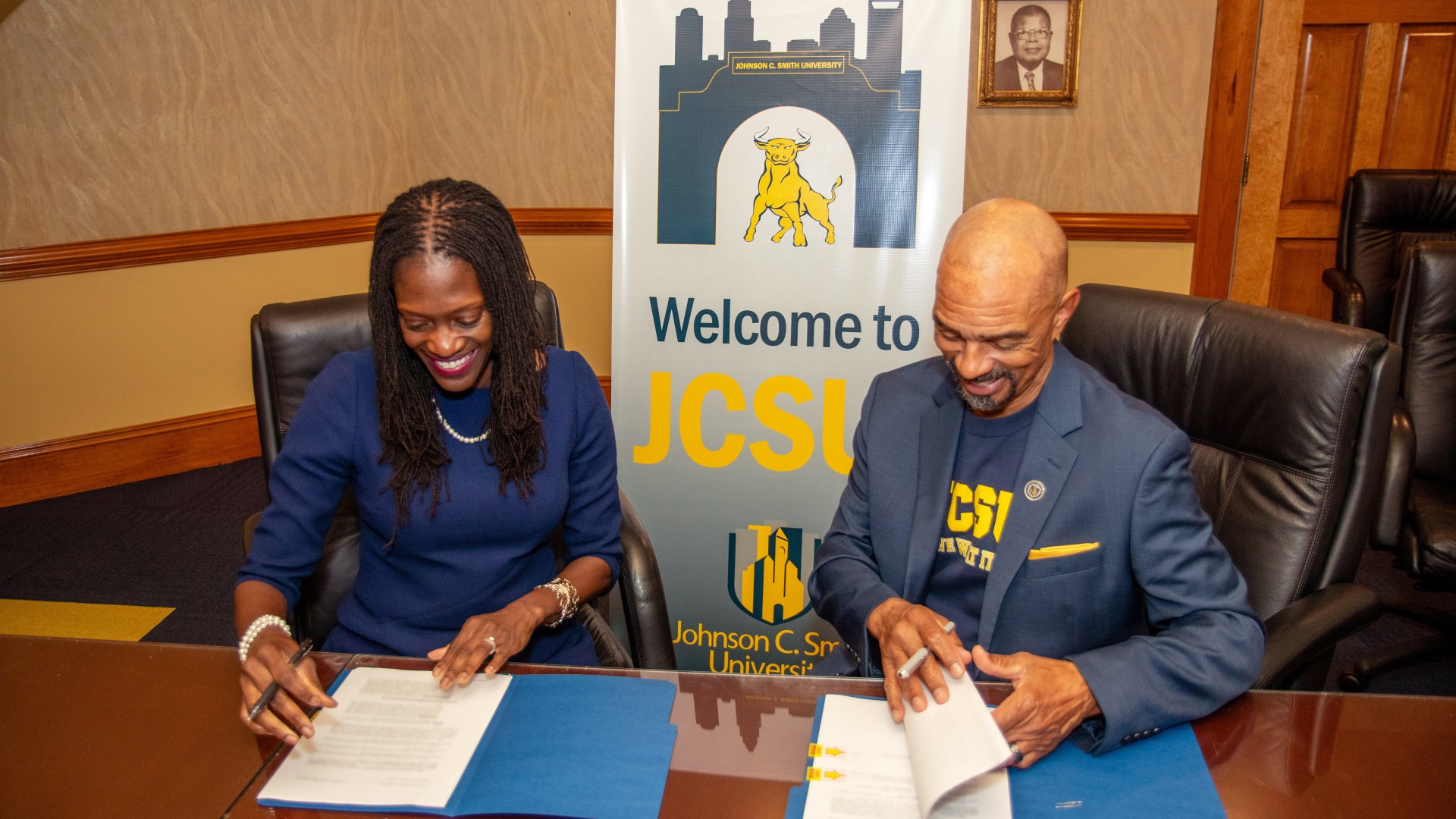 Dr. Valerie Kinloch and Trustee Steven L. Boyd look over the contracts