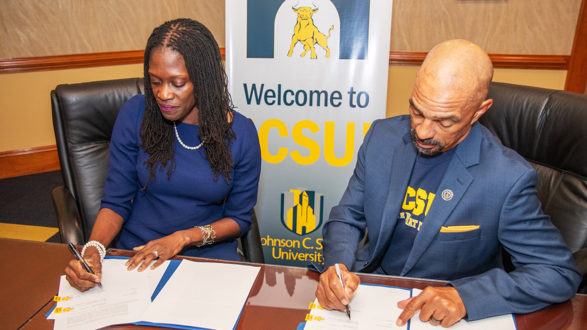 Dr. Valerie Kinloch and Trustee Steven L. Boyd signing the contracts