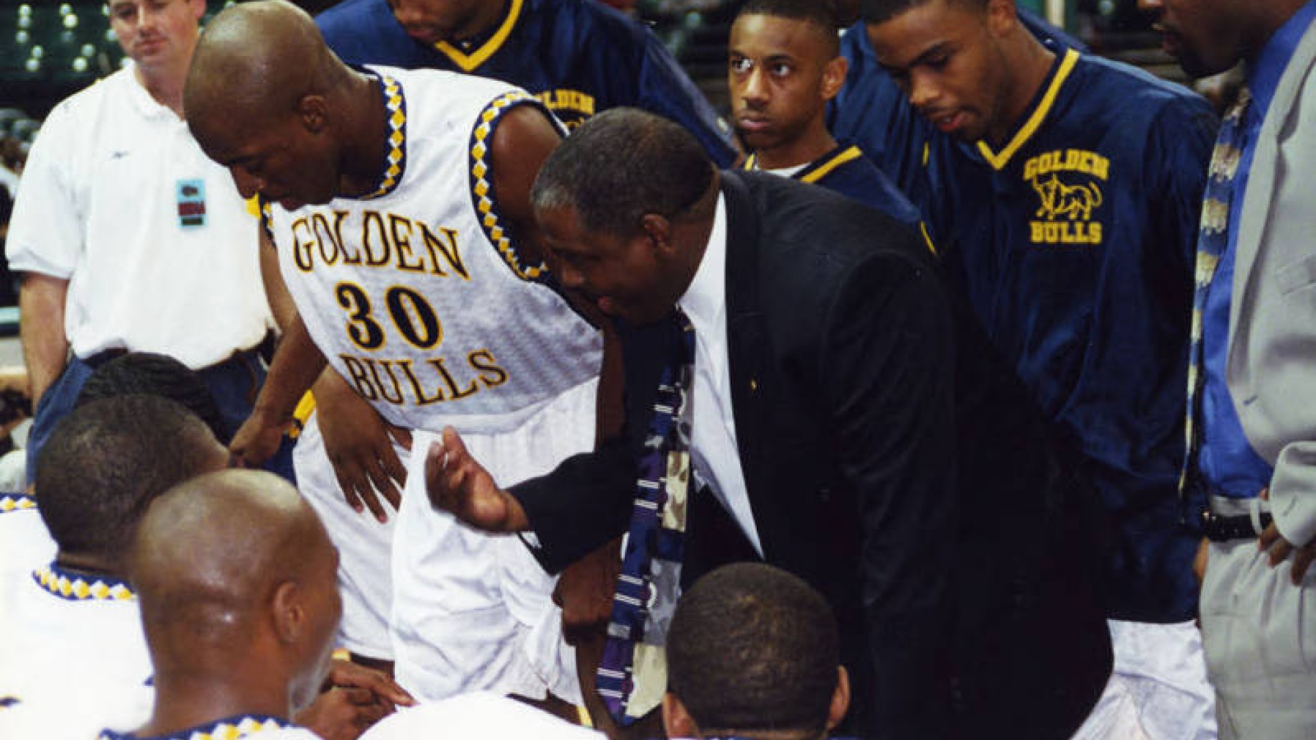 Steve Joyner Sr. Coaching the Golden Bulls Basketball Team in the huddle