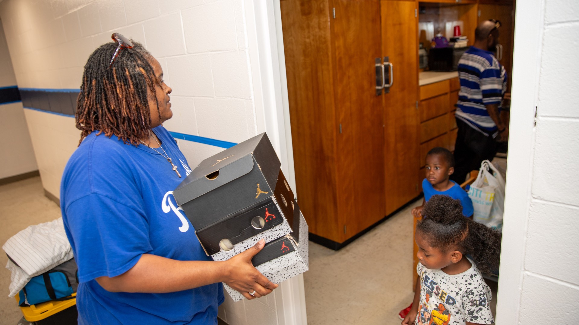 Woman carrying boxes into a room in Myers Hall during Freshman Move-in 2023