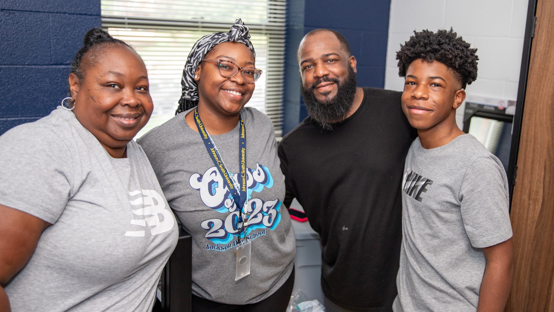 Family posing in a room in Greenfield Hall during Freshman Move in 2023