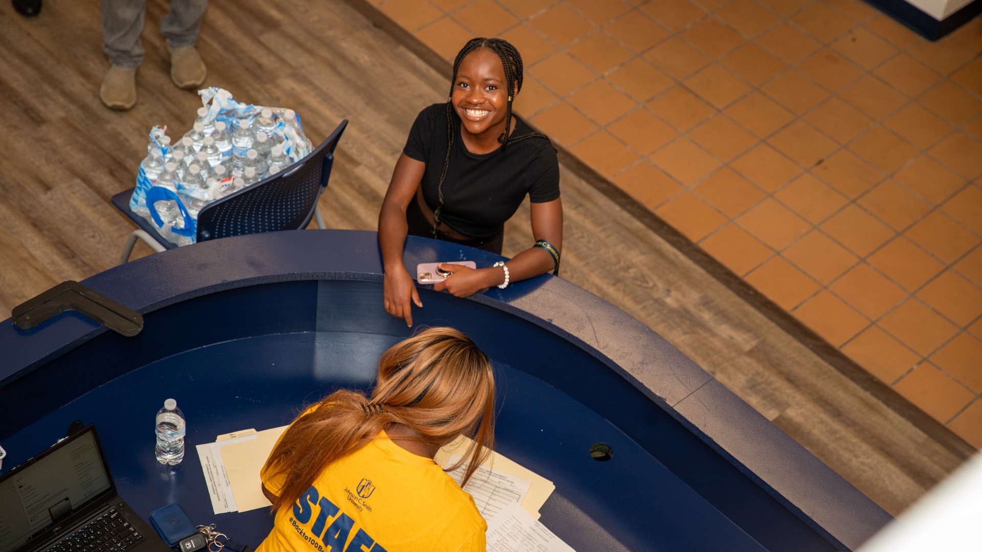 Student checking into the front desk at Greenfield Hall during Freshman Move-in 2023