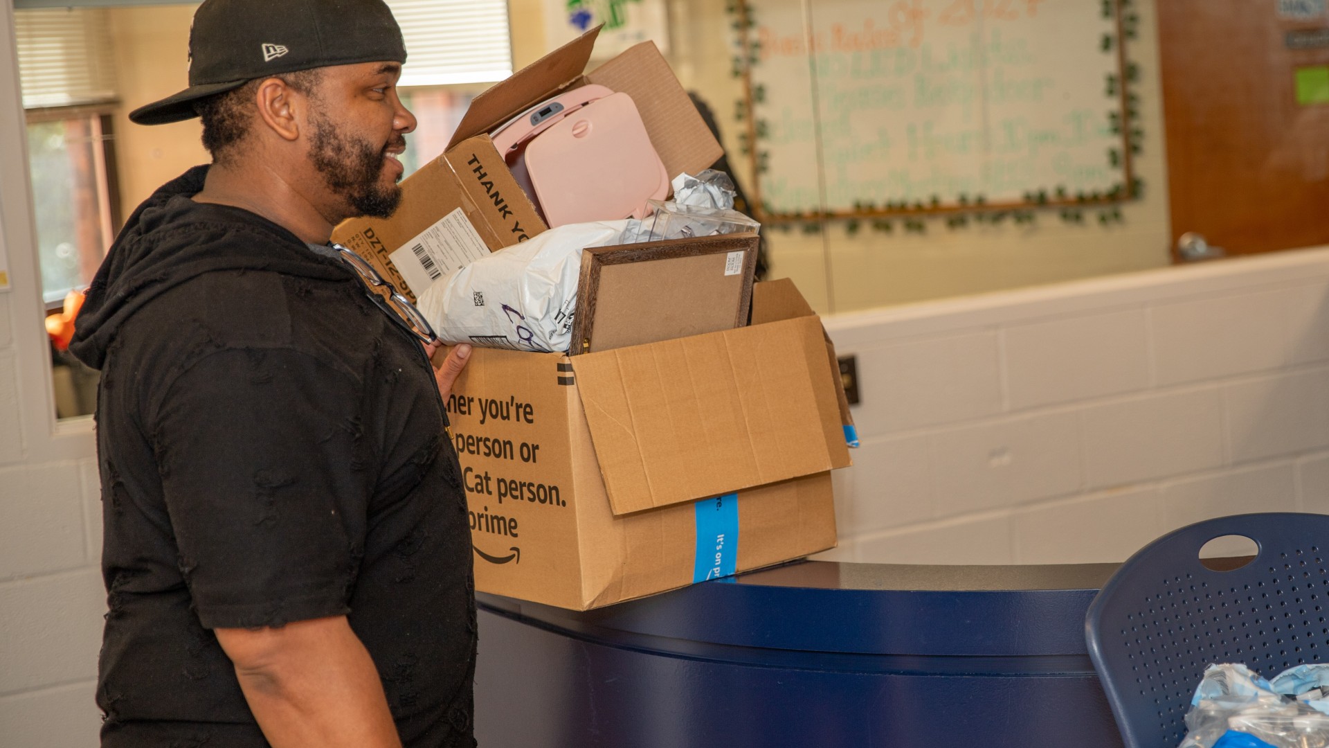 Parent waits at the desk at Greenfield while student checks in during Freshman Move in 2023