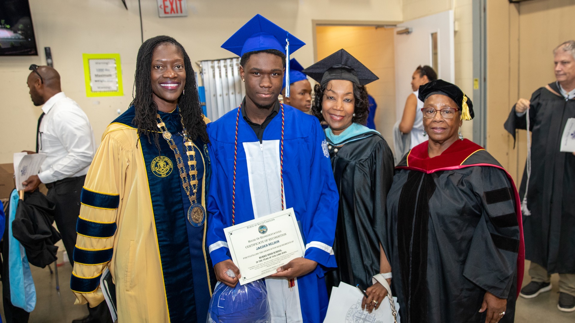 President Kinloch poses with students and administrators after the ceremony