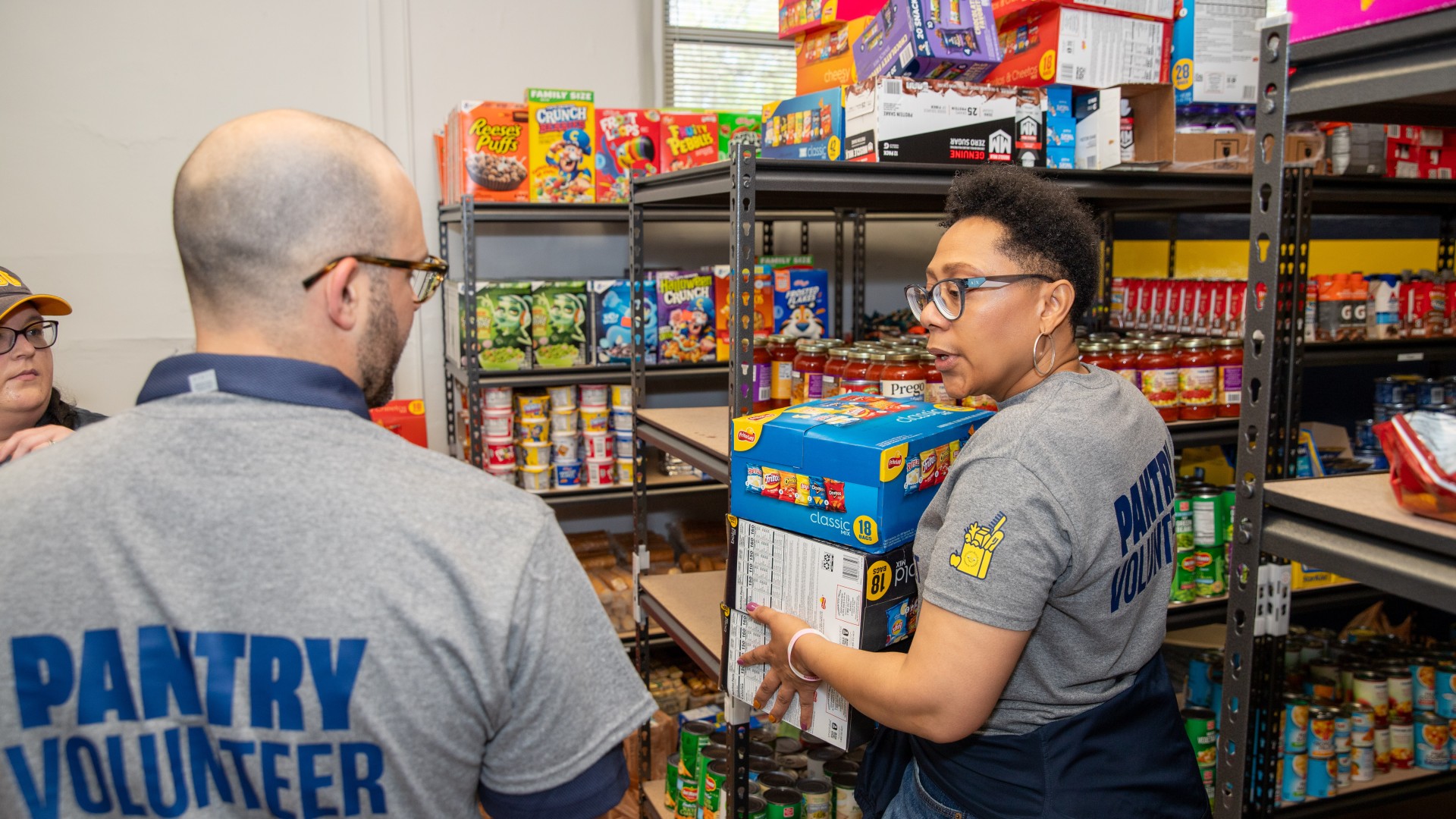 Dr. Haywood works with volunteers to restock the Golden Bulls Market