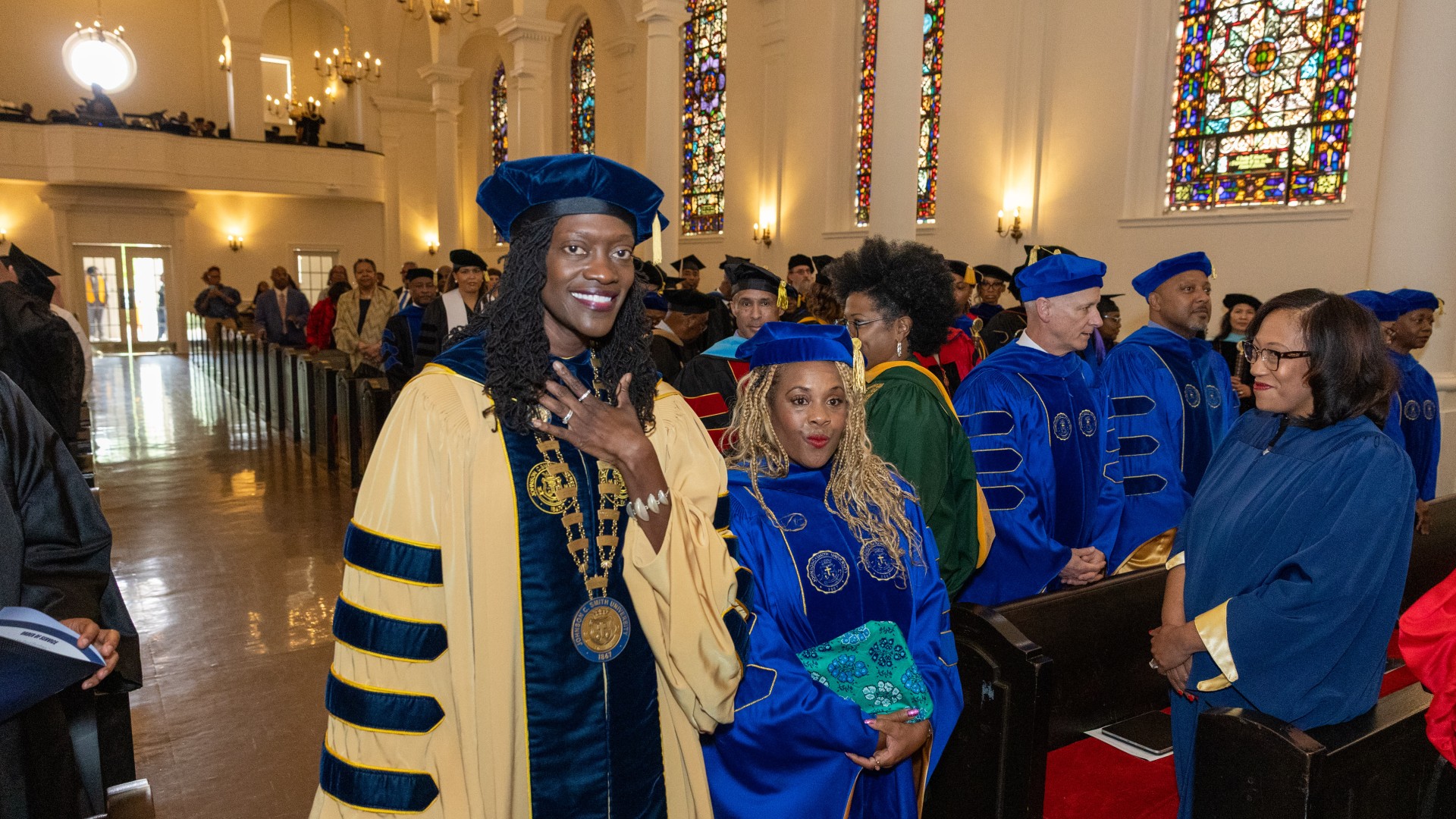 Dr. Valerie Kinloch processes in with Judge Tyyawdi Hands