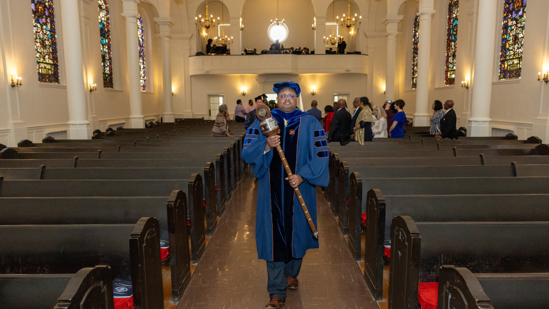 Dr. Martin processes in with the mace