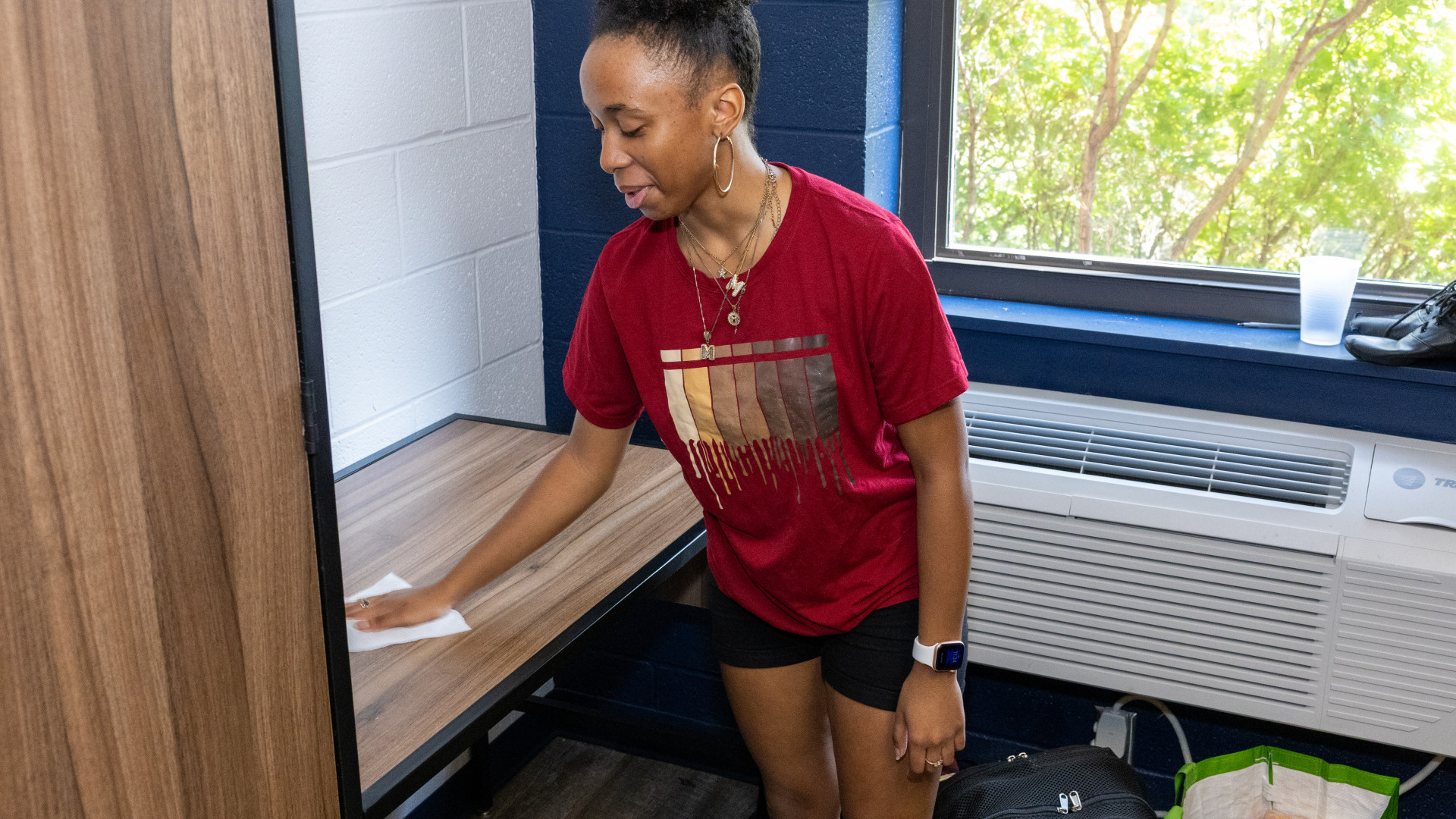 Student cleans their room during move in